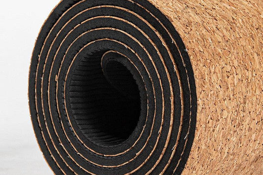 Rolled cork yoga mat close-up — non-slip grip for sweaty hands