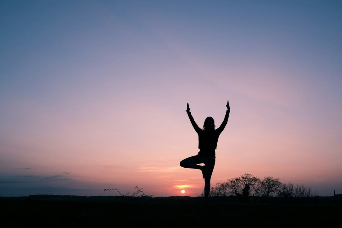 Calm tree pose at dusk — simple yoga exercises for more relaxation at home