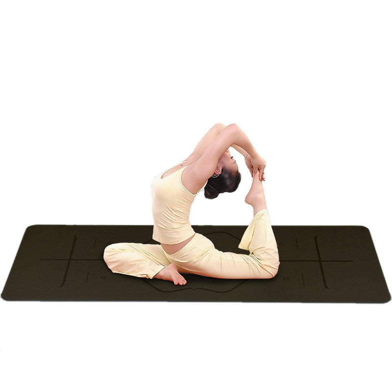 Woman in pigeon pose on a dark Peak Core yoga mat
