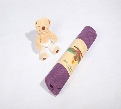 Rolled violet beginner yoga mat with gift packaging