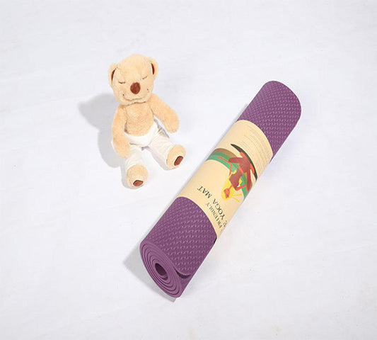 Rolled violet beginner yoga mat with gift packaging