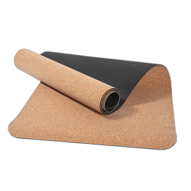 Eco-friendly cork yoga mat with dark TPE base, half rolled