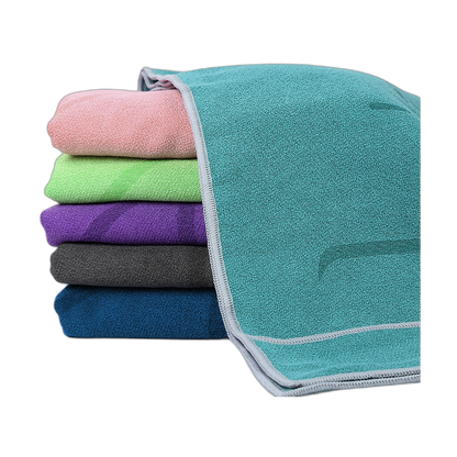 Stack of soft yoga towels in five rich colours
