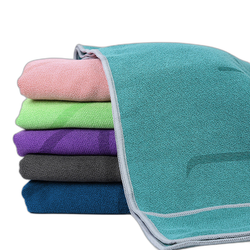 Stack of soft yoga towels in five rich colours